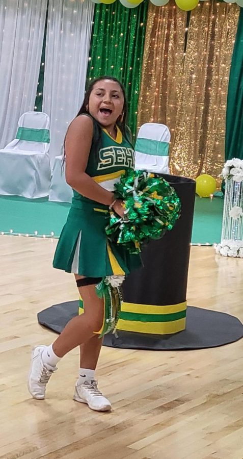 Cheerleader and freshman Jessica Mendoza showing off her school spirit while chanting a cheer at the homecoming pep rally.