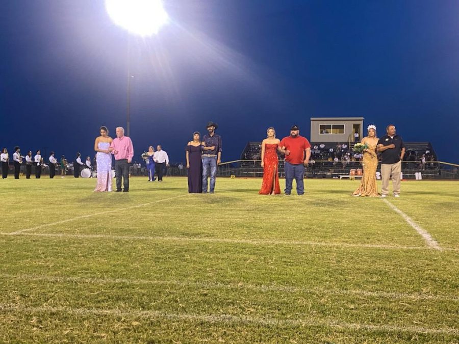 Senior homecoming candidates standing with their escorts during halftime. (Reading left to right): Annabelle Anchondo with escort Kevin Roberts, Abrie Escalante with father Javier Escalante, Jenna Bridges with father Carl Bridges, and Halee Toscano with father Gabriel Toscano.