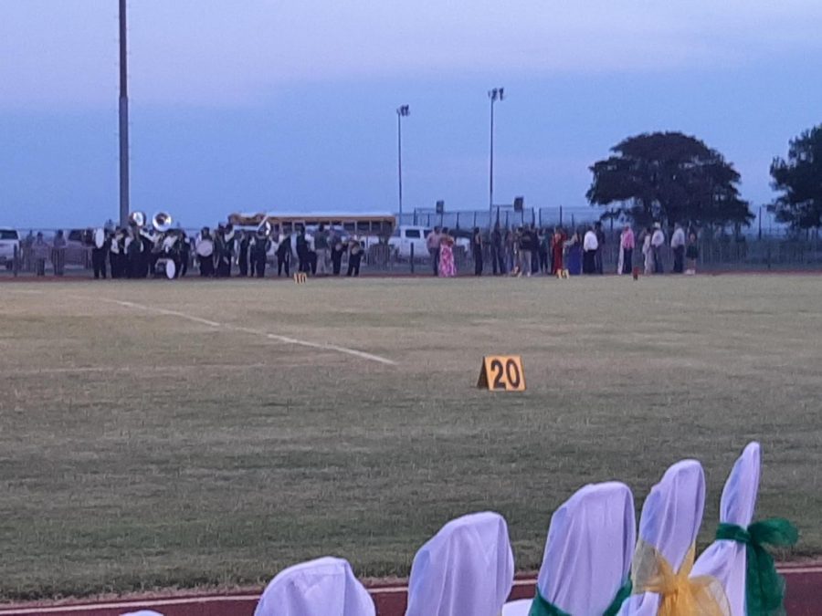 The SE band, girl homecoming candidates, and their fathers lined up on the track before performing and walking the field at halftime.