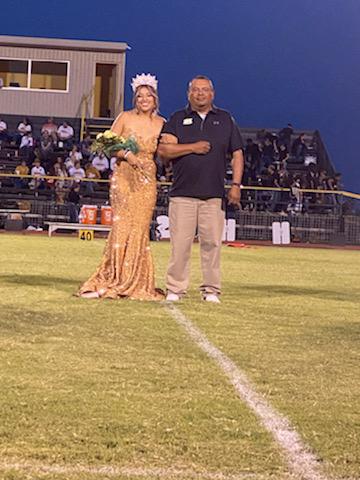 Senior and homecoming queen Halee Toscano being escorted by her father during halftime.